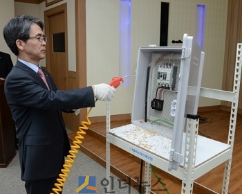 이윤배 농협손보 대표이사가 축산 농민들 앞에서 전기 차단기 내 먼지를 제거하는 작업을 시연하고 있다.