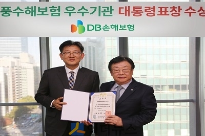 김정남 DB손보 사장(사진 오른쪽)과 전만권 행정안전부 재난복구 정책관이 기념촬영을 하고 있다.