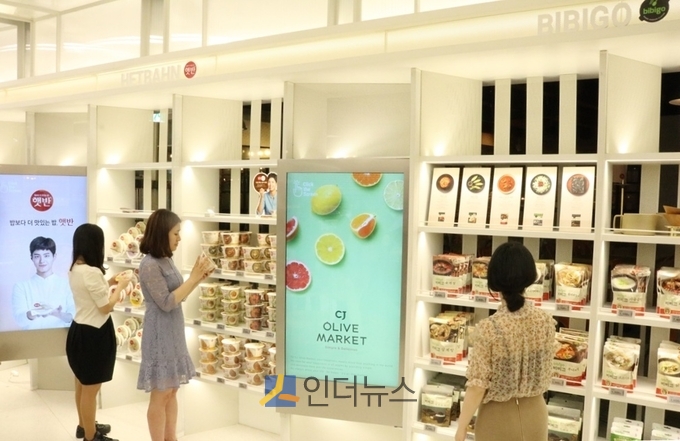 소비자들이 CJ올리브마켓에서 CJ제일제당 대표 HMR브랜드관을 둘러보고 있다.