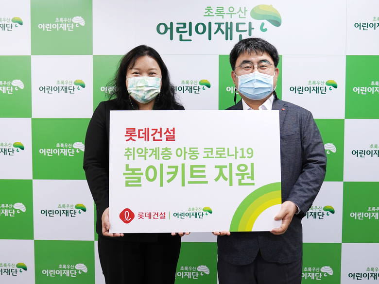 최운정 초록우산어린이재단 본부장과 한정호 롯데건설 상무(오른쪽)가 서울지역 아동을 위한 ‘놀이 키트’ 전달식을 진행했다. 사진ㅣ롯데건설