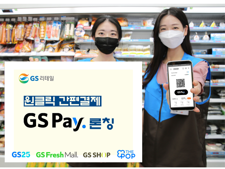 GS25에서 모델들이 GS페이 화면과 홍보물을 들고 포즈를 취하고 있습니다. 사진ㅣGS리테일