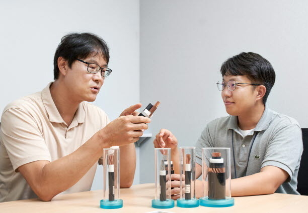 LS전선 직원들이 국내 최초로 개발한 AC·DC 겸용 PP 케이블에 대해 논의하고 있다. 사진|LS전선